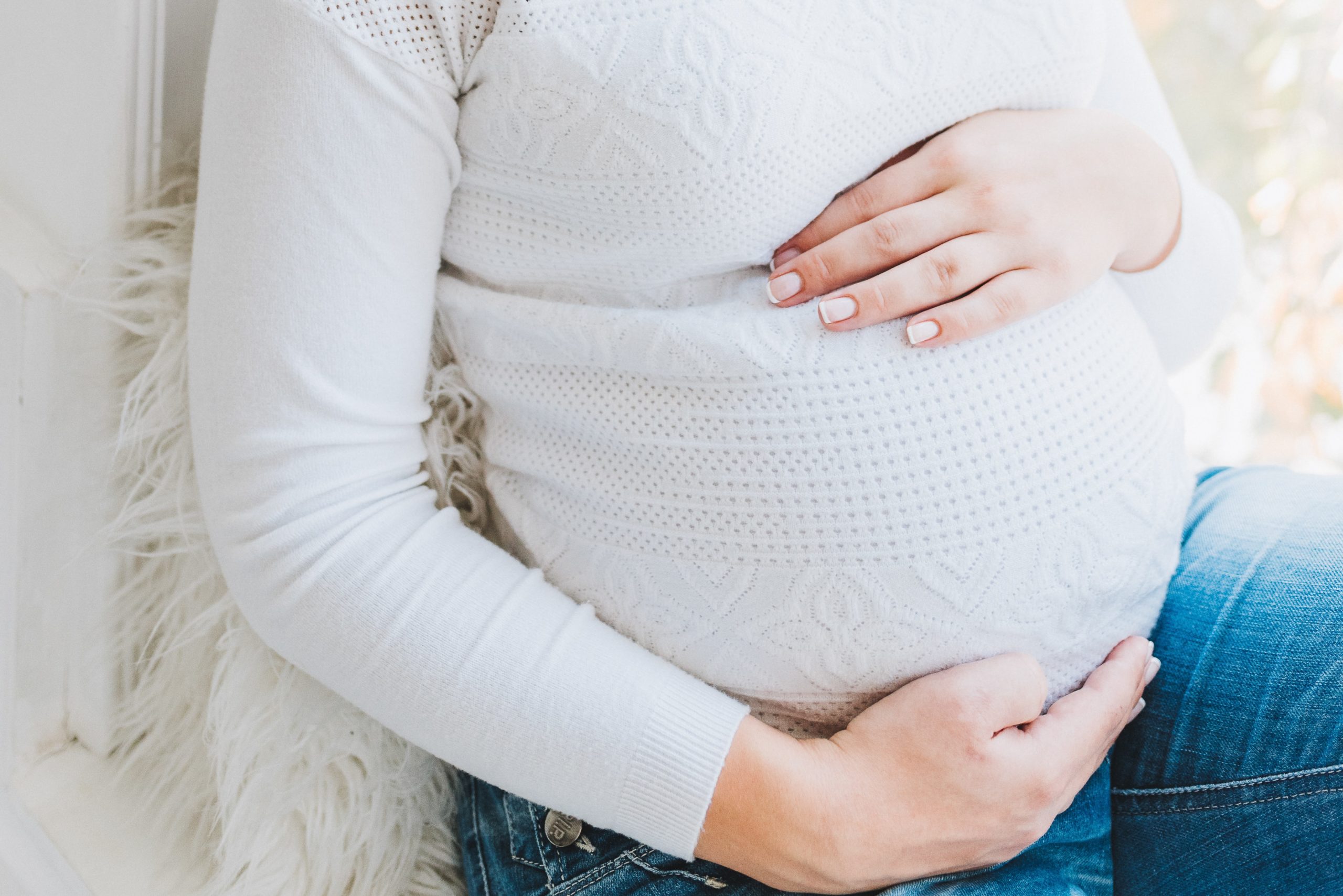 pregnant woman holding stomach