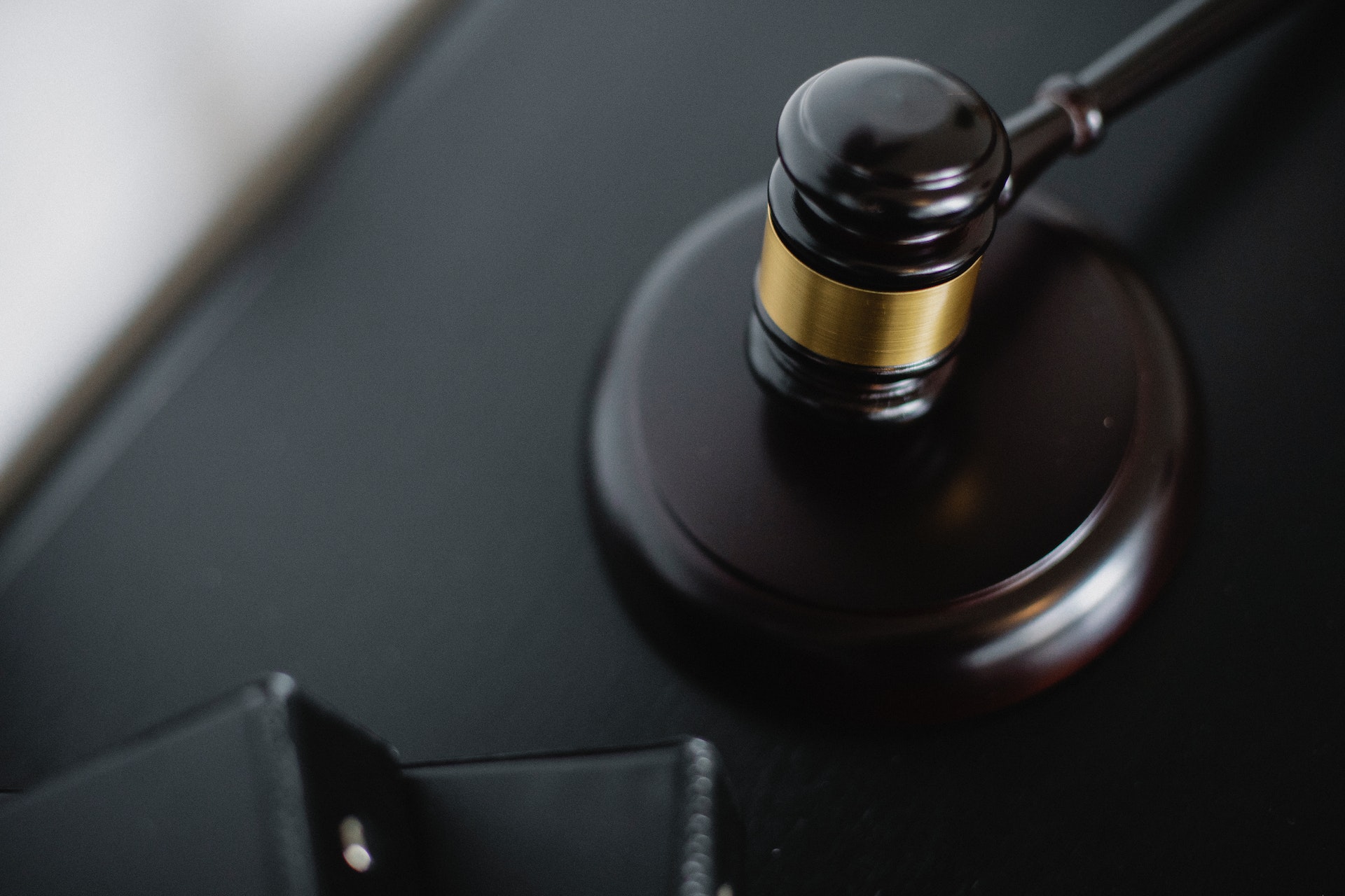 gavel resting on flat surface next to stack of books